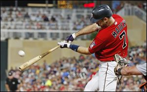 Minnesota Twins' Joe Mauer hits a three-run home run off Detroit Tigers pitcher Louis Coleman in the seventh inning.