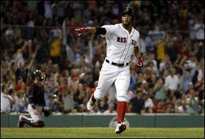 Boston Red Sox's Xander Bogaerts points to teammates in the dugout after one of his home runs against the Cleveland Indians.