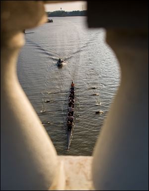 Members of the Perrysburg Rowing Club make their way under the Martin Luther King Jr. Bridge on the Maumee River in October of 2016.