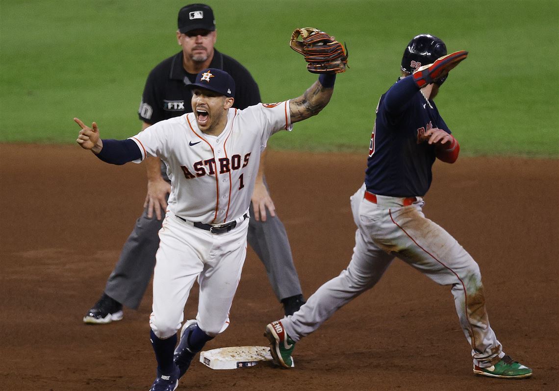 Houston Astros shortstop Carlos Correa throws to first base for