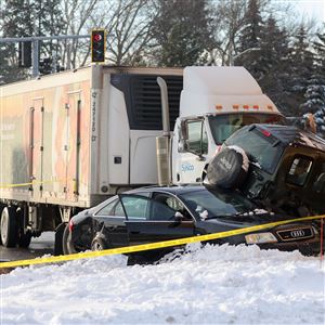 Two cars and a tractor-trailer are up against a Walgreens on the scene of a crash at Secor Road and Monroe Street.