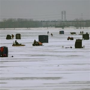 Ice fishing on Lake Erie can draw legions of anglers to the frozen waters, lured by the possibility of catching a trophy walleye. (THE BLADE)