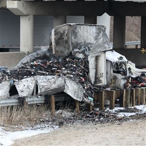 A burned tractor-trailer truck rests on the side of the road following a police chase and crash on northbound I-75 near Alexis Road March 10 in Toledo.