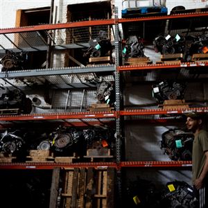 Mohamad Kanan, 25, of West Toledo, walks through the catalogued shelves of car engines at Greenbelt Auto Parts downtown Toledo on August 17. (THE BLADE/STEPHEN ZENNER)