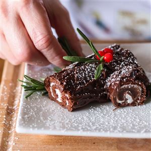 Mary Bilyeu adds rosemary as a garnish for her no-cook, no-bake, no-muss, no-fuss mini Buche de Noel made with Ho Hos and a can of prepared chocolate frosting. (Rebecca Benson)