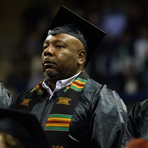 Rodney Braziel stands while being recognized during the University of Toledou2019s fall commencement ceremony at Savage Arena in Toledo on Dec. 17.