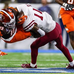 Bowling Greenu2019s Tau2019Ron Keith is brought down by New Mexico Stateu2019s Dylan Early during the 2022 Quick Lane Bowl at Ford Field in Detroit on Dec. 26.