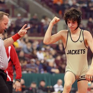 Perrysburgu2019s Cole Evans reacts as he wins against St. Edwardu2019s Adam Butler in the Division I title match for 106 pounds during the OHSAA wrestling championships at the Schottenstein Center at Ohio State University in Columbus on March 13.