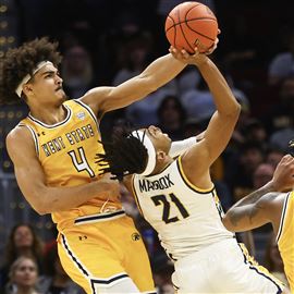 University of Toledo guard Dante Maddox Jr. shoots against Kent State forward Chris Payton during the MAC Basketball Tournament Championship, March 11, at the Rocket Mortgage FieldHouse in Cleveland.