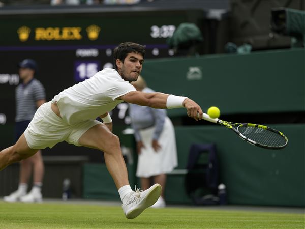At rainy Wimbledon, Alcaraz among those playing day after day, and winning