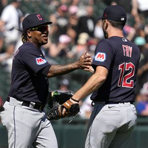 Cleveland Guardians' Kole Calhoun, right, is greeted at the plate by Jose  Ramirez (11) after hitting a home run against the Cincinnati Reds during  the third inning of a baseball game Tuesday