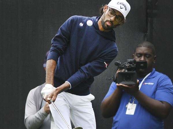 Bhatia shares lead in Detroit after his golf ball finds a fairway drain