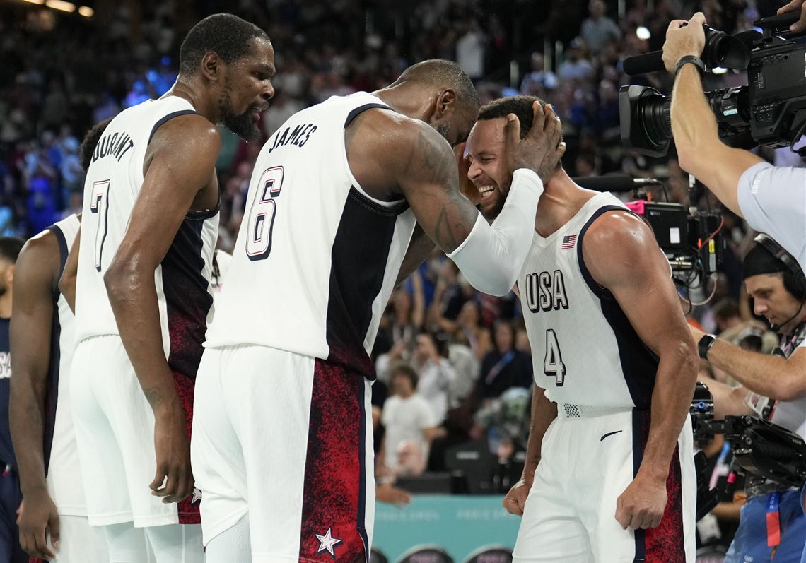 United States' Kevin Durant (7), LeBron James (6) and Steph Curry (4) celebrate after beating Serbia.